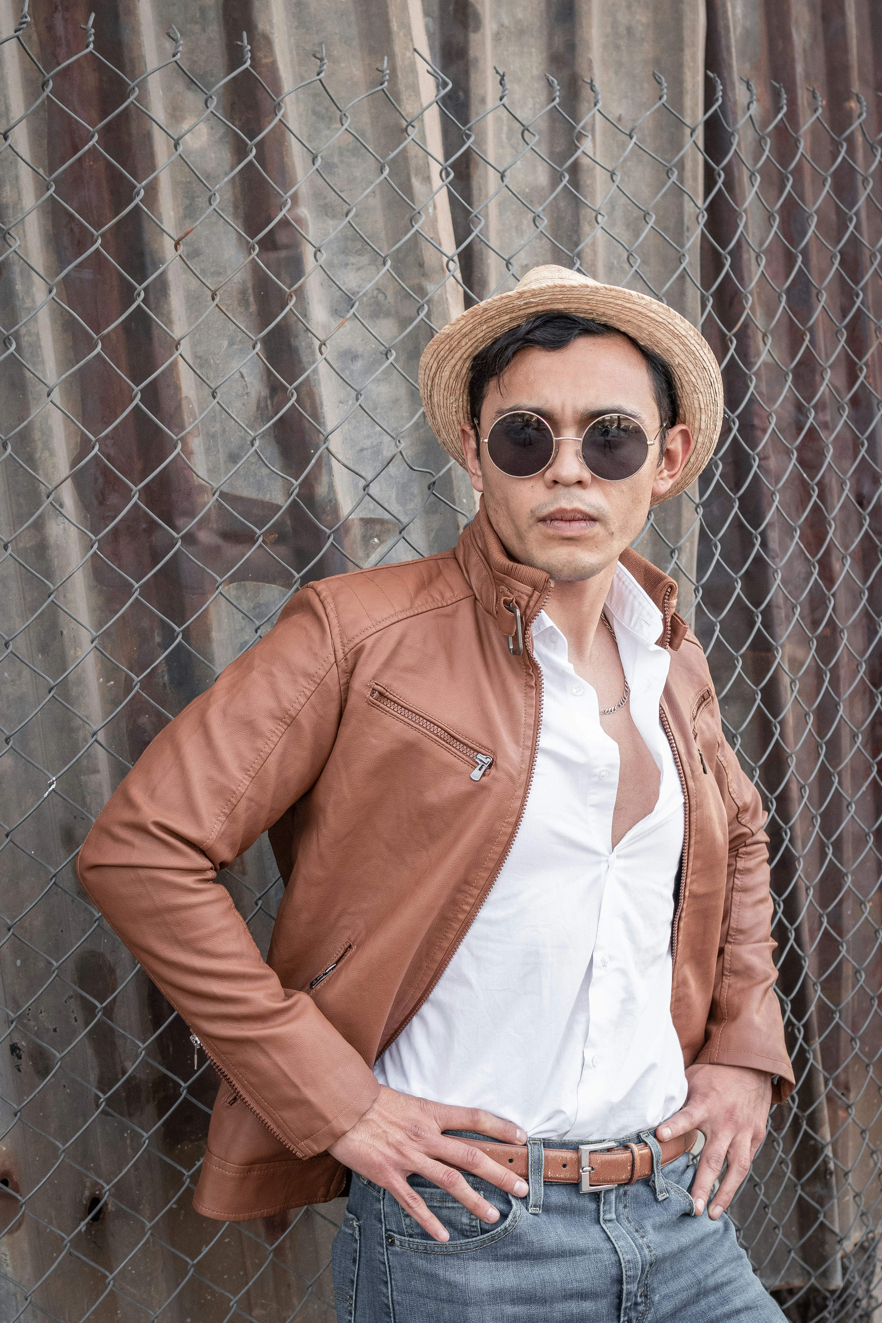 woman in brown leather jacket wearing brown sun hat